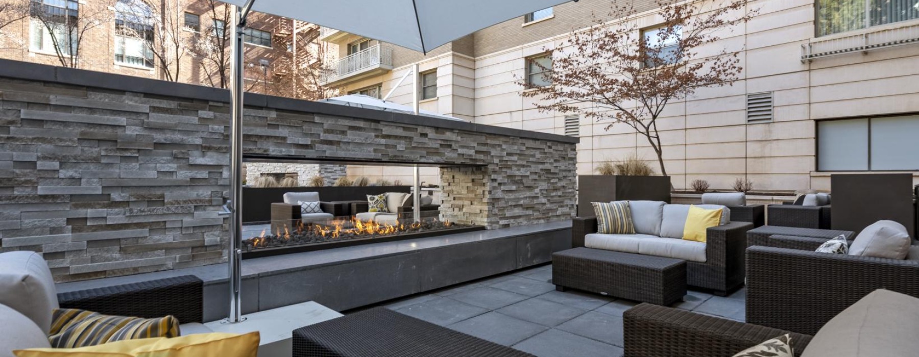 a patio with a couch and a table and chairs